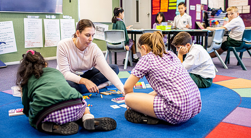 Teacher with students at Holy Cross Catholic Primary Glenwood